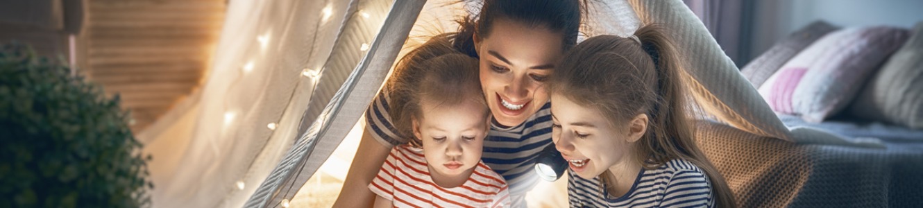 Mom with daughters under tent